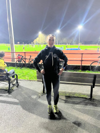 Julie Cobbold, a junior athletics coach for Highgate Harriers, smiling at the Parliament Hill track