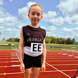 Highgate Harriers U11 athlete Charlotte Knipe running with determination during a cross-country race